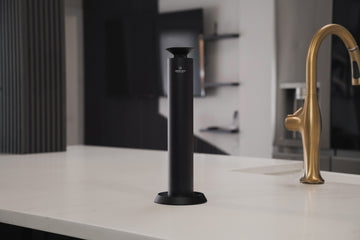 Aroma Max Mini Pro cold-air scent diffuser in black on a modern kitchen countertop