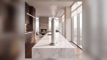 Aroma Max Mini Pro cold-air diffuser releasing a fine scented mist on a kitchen island