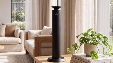 Aroma Max matte black Mini Pro cold-air diffuser on a wood console table
