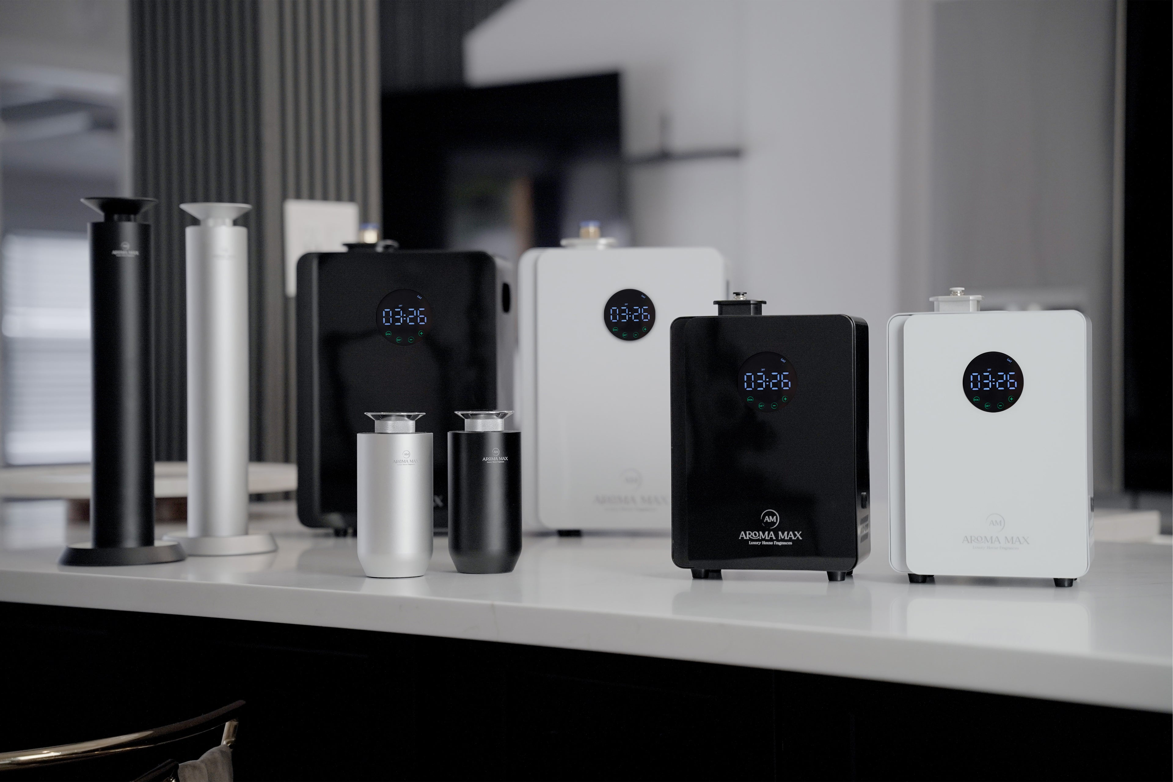 Aroma Max cold-air and HVAC scent diffuser product lineup on a modern kitchen counter