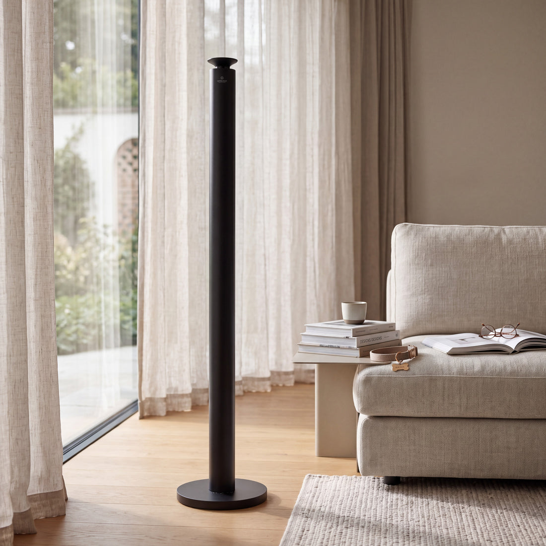 Aroma Max Mini Plus silver cold-air scent diffuser standing on the floor in a modern living room