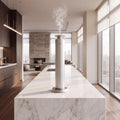 Aroma Max Mini Pro cold-air scent diffuser on a white marble kitchen island in a luxury home, scented mist rising